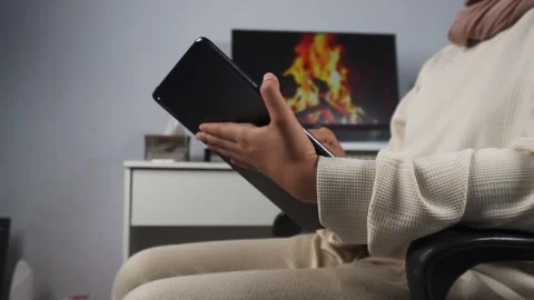 Women using tablet while sitting on a chair Stock Footage 276877147