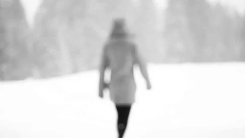 Women walk in a valley near forest during snowstorm, mountain, Italy Stock Footage