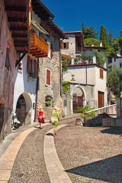 Women walking up a street up a hill, historic city of Arco, Italy Stock Photos