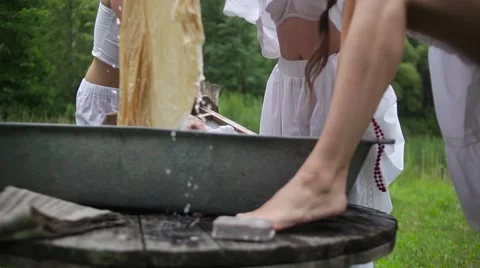 Women wash using a old fashioned washboard Stock Footage 64930841