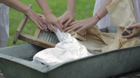 Women wash using a old fashioned washboard Stock Footage 64930880