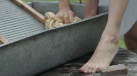 Women wash using a old fashioned washboard Stock Footage 64931018