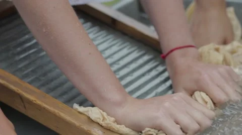 Women wash using a old fashioned washboard Stock Footage 64931024