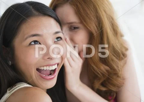Women whispering to each other Stock Photos