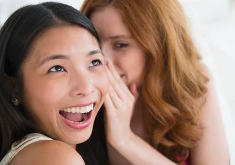 Women whispering to each other Stock Photos