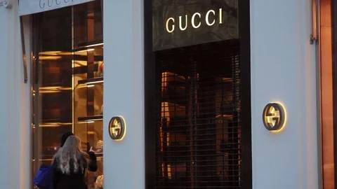 Women window shopping, Gucci expensive fashion shop, Kudamm street, Berlin Stock Footage