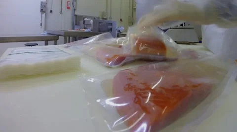 Women work on packaging of red fish at fish factory. Timelapse Stock Footage 68340513