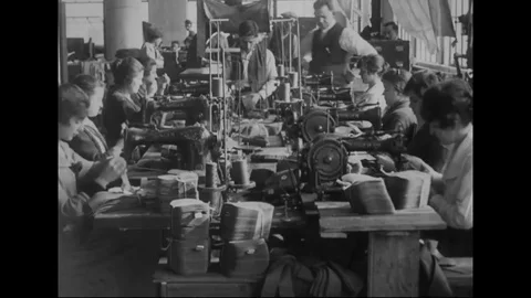 Women work on sewing machines while supervisor inspects their work - 1914-1918 Stock Footage 83700439