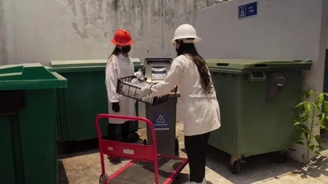 Women Workers Sort Plastic Waste for Recycling in Sustainable Construction Stock Footage 346643634