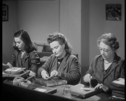 Women workers working in despatch room, preparing labels for film shipping 스톡 동영상 141057865