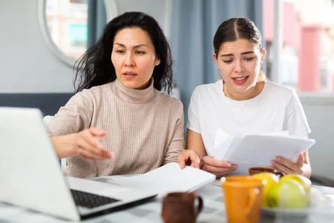 Women working on bill problem together Stock Photos