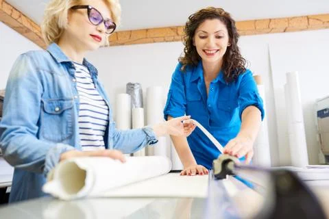 Women working with plotter in office Fotos de archivo