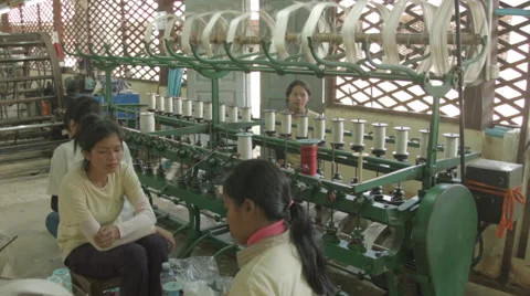 Women working on silk thread production machinery in Cambodia Stock Footage 48010074