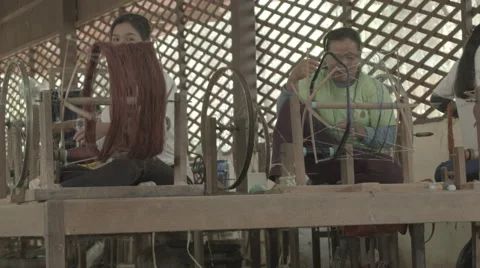 Women working with silk thread on wheels in Siem Reap Cambodia Stock Footage 48011730
