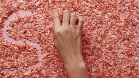 Women write word spa on the table full of sea salt. Concept spa, relax. Top view Video stock 138889643