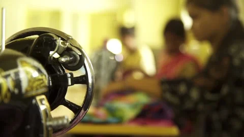 Women's are working while Sewing &amp; Stitching Machine is in the foreground Stock Footage 162078123