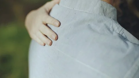 Women's arm around a man's back in the park on a date Stock-Footage 89150277