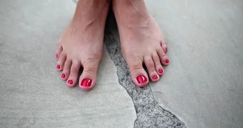 Women's bare feet with pedicure on a gra... | Stock Video | Pond5