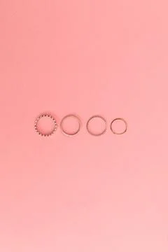 Women's bijouterie on pink background, object shot Stock Photos