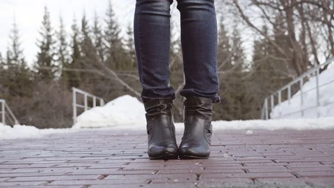 Women's boots on the brickwork are fun to play. They playfully dance to and fro. Stock Footage 105226328