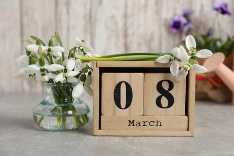 Women's day greeting card. Block calendar and beautiful snowdrops on grey tab Stock Photos