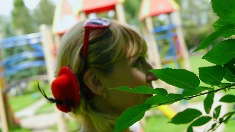Women's hairstyle with a red hat on the background of greenery Stock Footage 86155086