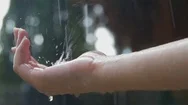 Women's Hand Covered In Droplets Of Heavy Rain Stock Footage