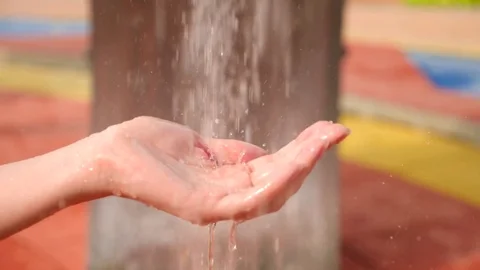 Womens hand covered in droplets of heavy rain in close-up, 4k, slow-motion Stock Footage