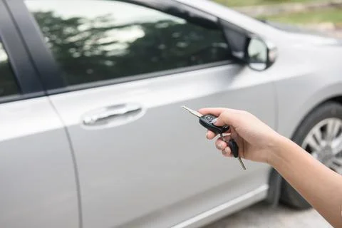 Women's hand presses on the remote control car systems Stock Photos