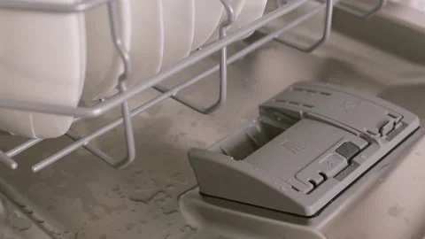 Women's hand is putting detergent tablet in automatic compartment in dishwasher Stock Footage 121058868