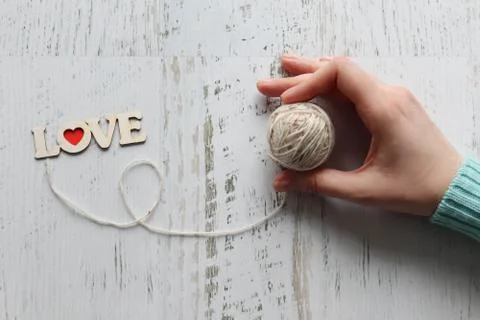 Women's hand with a tangle of threads, the concept of love for knitting Stock Photos