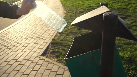 Womens hand throws an empty plastic bottle into the trash can Stock Footage 151434270