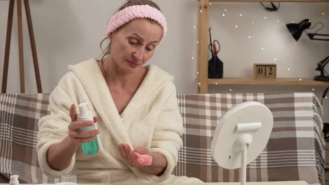 Women's hands applying special cosmetic foam to a facial cleansing brush, b.. Stock Footage 340910558