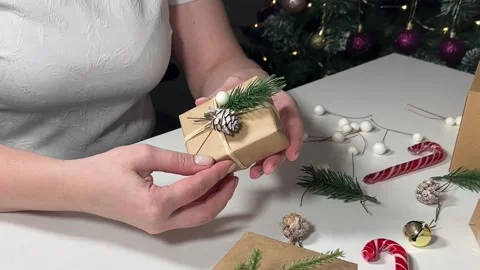 Women's hands are holding a box with a gift for christmas Stock Footage 258467576