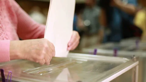 Women's hands are placed electoral billeting in the ballot box. Stock Footage