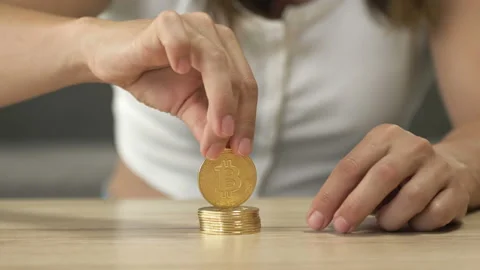Women's hands are playing with a stack of bitcoins. Stock Footage 207507945