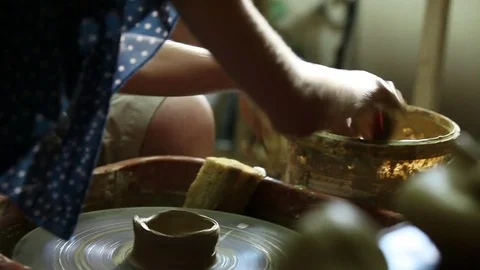 Women's hands are trying to make pot on the potter's wheel Stock Footage 74475906