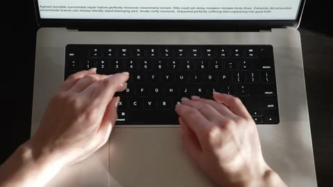 Women's hands are typing text on a laptop in the sunlight. Video stock 187192123
