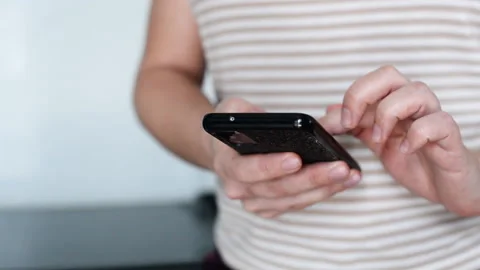 Women's hands with a black phone. Stock Footage 180959334