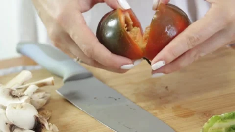 Womens hands break fresh pepper into two parts. The inside of the pepper Stock Footage 315028516