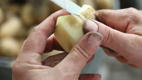 Women's hands clean potatoes Stock Footage 89100034