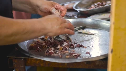 Women's hands clean small fish with their hands at the fish market. Fish Stock Footage 201070319