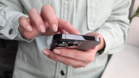 Women's hands close-up will cut a ribbon on a smartphone Stock Footage 255040663