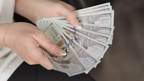 Women's hands count dollar banknotes Video stock 232684221