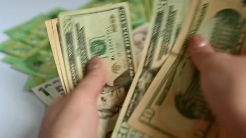 Women's hands count US dollars against the background of the euro. Stock Footage 248253900
