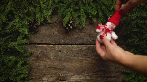 Women's hands create a Christmas decor. Christmas tree branches with cones and Stock Footage 82418029