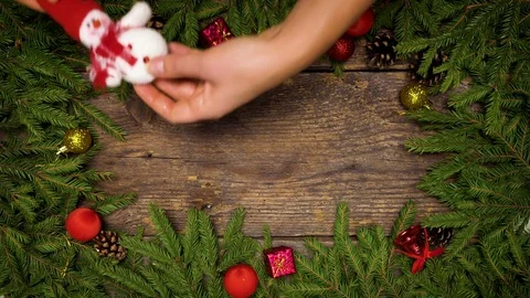 Women's hands create a Christmas decor. Christmas tree branches with cones and Stock Footage 83141029
