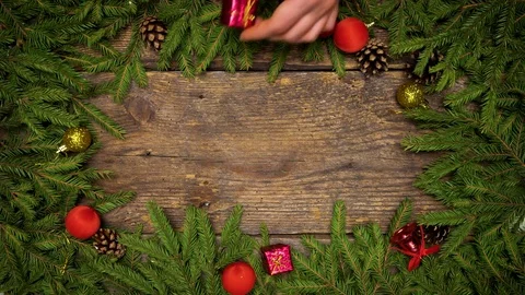 Women's hands create a Christmas decor. Christmas tree branches with cones and Stock Footage 83296703