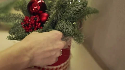 Women's hands create a Christmas New Year's composition with fir branches Stock Footage 223735593