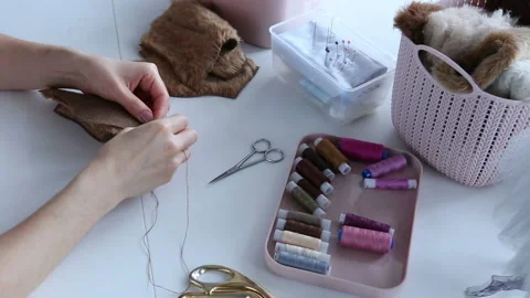 Women's hands create a textile product, toy, pattern Stock Footage 88226527
